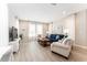 Bright living room with tile flooring, large windows, and modern furniture at 4379 Nw 56Th Ct, Ocala, FL 34482