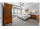 Comfortable main bedroom featuring plush carpeting, tray ceiling and abundant natural light from three windows at 4379 Nw 56Th Ct, Ocala, FL 34482