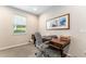 Bright home office featuring a wooden desk, rolling chair, and a window for natural light at 4379 Nw 56Th Ct, Ocala, FL 34482