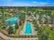 Aerial view of sparkling pools, palm trees, and lush landscaping in the community's recreational area at 4379 Nw 56Th Ct, Ocala, FL 34482