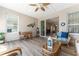 Bright and airy sunroom featuring tile floors, comfortable seating, ceiling fan and outside access at 4379 Nw 56Th Ct, Ocala, FL 34482