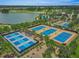 Overhead view of pristine tennis courts offering a great recreational opportunity for residents at 4379 Nw 56Th Ct, Ocala, FL 34482