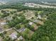Expansive aerial view showcases a residential area with lush greenery and scattered houses, some featuring private pools at 4430 Se 47Th Pl, Ocala, FL 34480