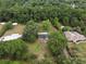 Aerial view displays a home surrounded by mature trees and lush landscaping providing a serene and private setting at 4430 Se 47Th Pl, Ocala, FL 34480