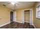 Inviting bedroom with light-yellow walls, wood-look floors, and closet at 4430 Se 47Th Pl, Ocala, FL 34480