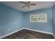 Bright bedroom with light-blue walls, wood-look floors, and natural lighting at 4430 Se 47Th Pl, Ocala, FL 34480