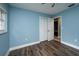 Cozy bedroom with light-blue walls, wood-look floors, and natural lighting at 4430 Se 47Th Pl, Ocala, FL 34480