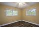 Bright bedroom with light-yellow walls, wood-look floors, and natural lighting at 4430 Se 47Th Pl, Ocala, FL 34480