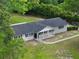 An aerial view of a single story house with a spacious yard, sidewalk and lush trees at 4430 Se 47Th Pl, Ocala, FL 34480