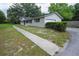 A view of the home's side and front showing the attached garage and adjacent sidewalk at 4430 Se 47Th Pl, Ocala, FL 34480