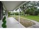 The house has a long, covered front porch supported by white columns and green shrubs at 4430 Se 47Th Pl, Ocala, FL 34480