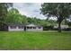 Charming home with a manicured lawn and inviting front porch at 4430 Se 47Th Pl, Ocala, FL 34480