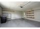 Garage with overhead lighting and built-in storage shelving at 4430 Se 47Th Pl, Ocala, FL 34480