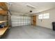 Garage with a white door, overhead lighting and built-in storage shelves at 4430 Se 47Th Pl, Ocala, FL 34480