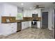 Well-lit kitchen features stainless appliances, sleek countertops, and ample cabinet space at 4430 Se 47Th Pl, Ocala, FL 34480