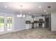 Open-concept kitchen with stainless appliances flows into a spacious dining area at 4430 Se 47Th Pl, Ocala, FL 34480