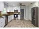 Bright kitchen boasts stainless appliances, stylish backsplash, and white cabinets at 4430 Se 47Th Pl, Ocala, FL 34480