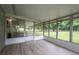 Screened porch with wood floors overlooking the backyard at 4430 Se 47Th Pl, Ocala, FL 34480