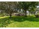 Expansive backyard featuring lush greenery and a screened pool area at 4530 Nw 78Th Ave, Ocala, FL 34482