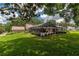 Wide backyard with screened pool area and well-maintained landscaping at 4530 Nw 78Th Ave, Ocala, FL 34482