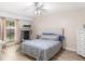 Well-lit bedroom featuring a queen-sized bed, wood floors, and a ceiling fan at 4530 Nw 78Th Ave, Ocala, FL 34482