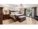 Spacious primary bedroom with wood floors, decorative accents, and backyard access at 4530 Nw 78Th Ave, Ocala, FL 34482