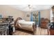 Cozy bedroom with wood flooring, natural light, and comfortable furnishings creating a relaxing atmosphere at 4530 Nw 78Th Ave, Ocala, FL 34482