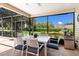 Covered and screened outdoor dining area with elegant white table and chairs, perfect for al fresco meals at 4530 Nw 78Th Ave, Ocala, FL 34482