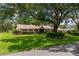 Charming ranch-style home featuring a manicured lawn and mature shade trees at 4530 Nw 78Th Ave, Ocala, FL 34482
