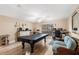 Spacious game room with pool table, natural light, and a separate office area at 4530 Nw 78Th Ave, Ocala, FL 34482