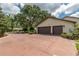 Spacious two-car garage featuring matching doors and an expansive driveway at 4530 Nw 78Th Ave, Ocala, FL 34482