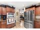 Gourmet kitchen with stainless steel appliances, granite countertops, and an adjacent game room at 4530 Nw 78Th Ave, Ocala, FL 34482