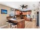 Eat-in kitchen featuring granite countertops, a breakfast bar, stainless appliances, and a ceiling fan at 4530 Nw 78Th Ave, Ocala, FL 34482