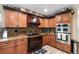 Well-lit kitchen featuring granite countertops, wood cabinets, and stainless steel appliances at 4530 Nw 78Th Ave, Ocala, FL 34482