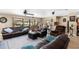 Spacious living room with a large sectional sofa, tile floors, and views of the backyard at 4530 Nw 78Th Ave, Ocala, FL 34482