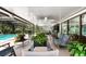 Expansive covered patio overlooking the pool, featuring various seating areas and serene outdoor living at 4530 Nw 78Th Ave, Ocala, FL 34482