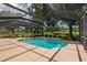 A serene enclosed pool area with inviting outdoor furniture at 4530 Nw 78Th Ave, Ocala, FL 34482