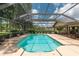 Refreshing pool with screened enclosure, offering a perfect blend of relaxation and recreational space at 4530 Nw 78Th Ave, Ocala, FL 34482