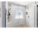 Modern shower with rainfall showerhead, pebble floor, and window at 4530 Nw 78Th Ave, Ocala, FL 34482