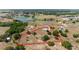 Large acreage featuring a modern home and possible farm with surrounding pond and light woods, highlighted by red property lines at 5489 Nantahala Ln, Lady Lake, FL 32159