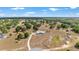 Expansive property featuring a modern home, long driveway, and natural landscaping with scattered trees under a bright, sunny sky at 5489 Nantahala Ln, Lady Lake, FL 32159