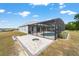 Stunning backyard features a screened pool area, fire pit, and outdoor patio at 5489 Nantahala Ln, Lady Lake, FL 32159