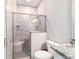 Modern bathroom features a gray tile shower with bench, glass doors, and sleek fixtures at 5489 Nantahala Ln, Lady Lake, FL 32159