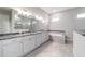 Bright bathroom with dual sinks, soaker tub, large shower, and granite countertops at 5489 Nantahala Ln, Lady Lake, FL 32159
