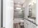 Bathroom featuring modern vanity with granite counters, shower over bath and wood style flooring at 5489 Nantahala Ln, Lady Lake, FL 32159