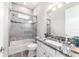 Tastefully designed bathroom featuring tiled shower over bath and a modern vanity with granite counters at 5489 Nantahala Ln, Lady Lake, FL 32159