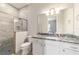 Modern bathroom with granite countertop, a walk-in shower with marble tile, and white cabinets at 5489 Nantahala Ln, Lady Lake, FL 32159