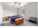 Cozy bedroom featuring a ceiling fan, window and a wooden chest for extra storage space at 5489 Nantahala Ln, Lady Lake, FL 32159