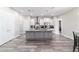 The kitchen includes white cabinets, stainless steel appliances, and a gray island at 5489 Nantahala Ln, Lady Lake, FL 32159