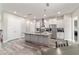 A kitchen with an island, stainless steel appliances, white cabinets, and pendant lighting at 5489 Nantahala Ln, Lady Lake, FL 32159